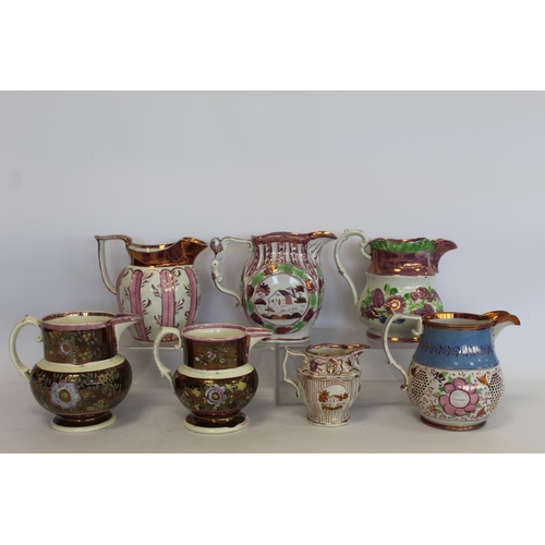 276 - Graduated pair of 19th century pottery jugs with copper and pink lustre banding and polychrome paint... 