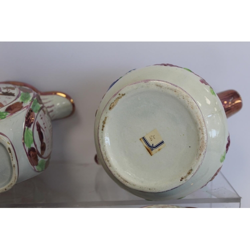 276 - Graduated pair of 19th century pottery jugs with copper and pink lustre banding and polychrome paint... 