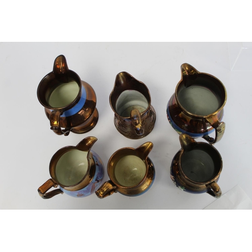 277 - Six Victorian copper lustre jugs, four with moulded decoration, the largest 16.5cm high.  (6).