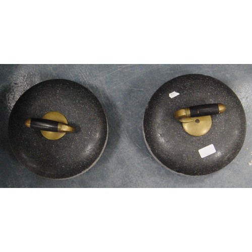 167 - Pair of curling stones, each with a brass and wood grip.  (2)