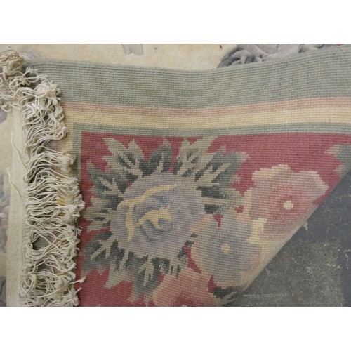 454 - Chinese large wool on cotton carpet, the cream field with all over floral decoration in pink and gre... 