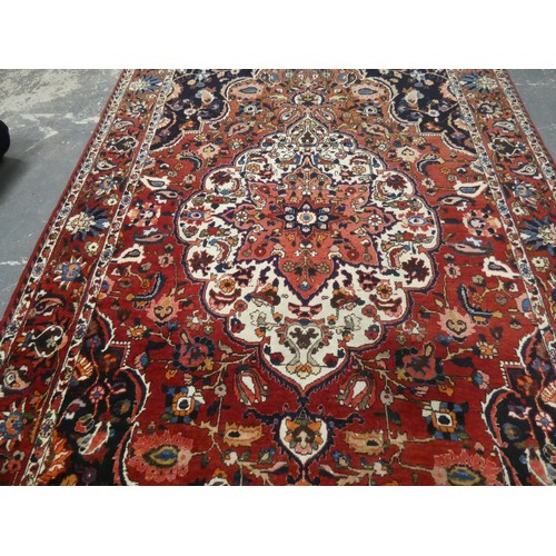 455 - Persian Bahktiari rug, the hand knotted rug with central floral medallion within all over floral mot... 