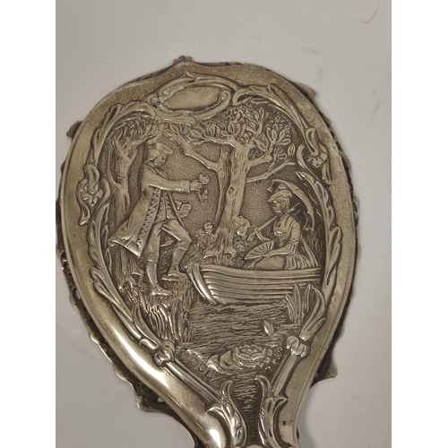 107 - Silver hand mirror, embossed with a couple in a landscape with trees, and matching hair brushes, by ... 