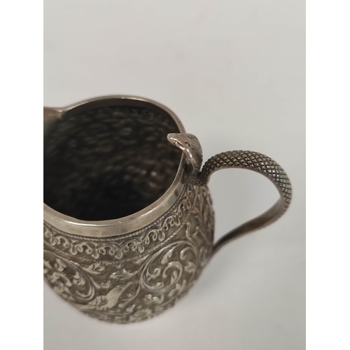 108 - Indian embossed silver cream jug, with serpent handle and a similar jar and cover, 198g / 6oz.