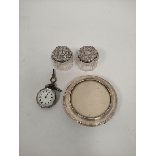 118 - Geneva silver watch and two mounted glass jars and a circular photograph frame for 67mm.