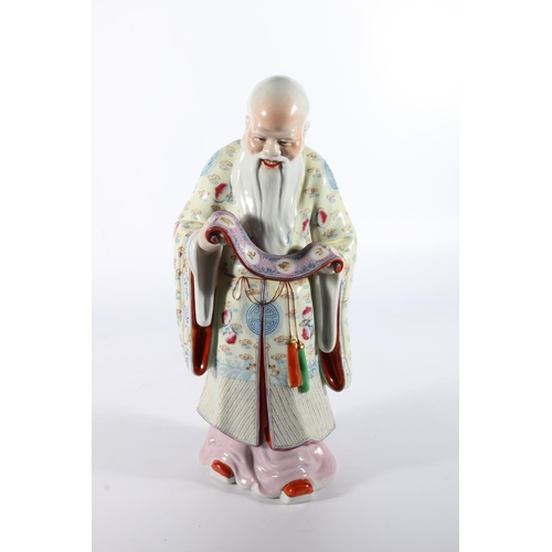 106 - Chinese porcelain figure of god holding scroll, 35cm tall.