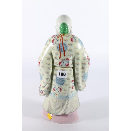 106 - Chinese porcelain figure of god holding scroll, 35cm tall.