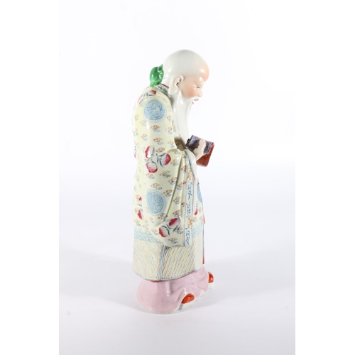 106 - Chinese porcelain figure of god holding scroll, 35cm tall.