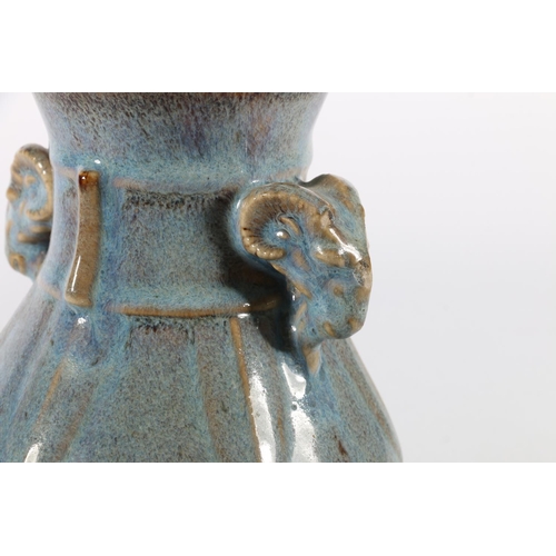 114 - Chinese pottery baluster vase with mottled blue glaze and Rams head mask handles, 17cm tall.