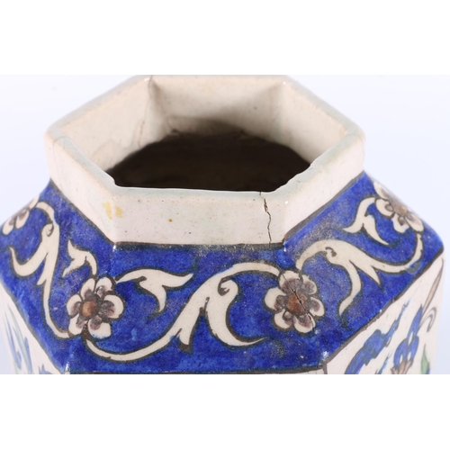 120 - Hexagonal pottery jar decorated with Persian Iznik type design, 17cm tall.