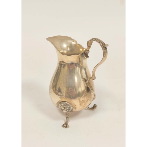 102 - Silver cream jug of Georgian style, pear shaped on lion mask and paw feet, London 1906. 100g, 3oz.