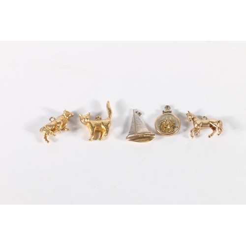 82 - Collection of 9ct gold charms including horse, cat, cow, boat, etc. 17.6g