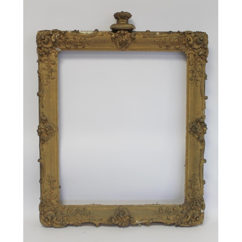 298 - 19th century gilt picture frame with floral and foliate scroll gesso moulding, the top surmounted by... 