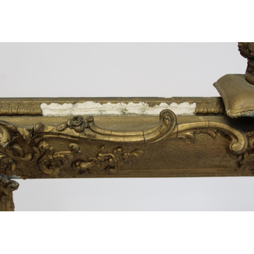 298 - 19th century gilt picture frame with floral and foliate scroll gesso moulding, the top surmounted by... 