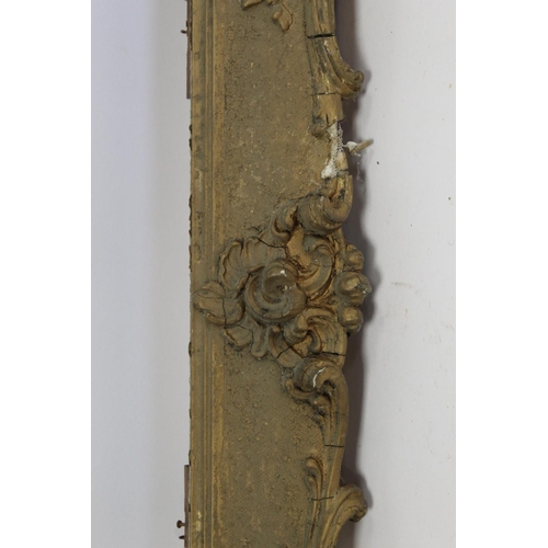 298 - 19th century gilt picture frame with floral and foliate scroll gesso moulding, the top surmounted by... 