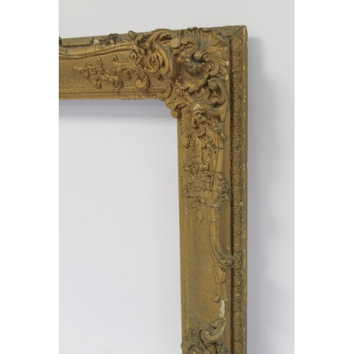 298 - 19th century gilt picture frame with floral and foliate scroll gesso moulding, the top surmounted by... 