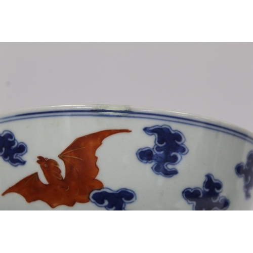 319 - 18th century Chinese porcelain circular bowl decorated with bats amongst clouds, in iron red, blue a... 