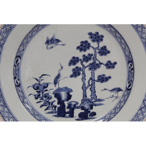 322 - 18th century Chinese export blue and white circular charger, the central panel depicting cranes in a... 