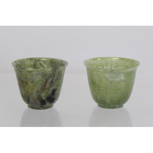 324 - Pair of Chinese mottled green jade cups, each 5cm high.  (2).