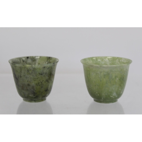 324 - Pair of Chinese mottled green jade cups, each 5cm high.  (2).