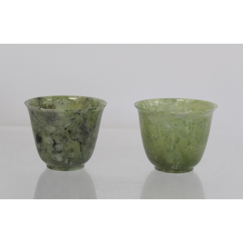 324 - Pair of Chinese mottled green jade cups, each 5cm high.  (2).