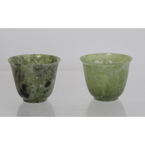 324 - Pair of Chinese mottled green jade cups, each 5cm high.  (2).