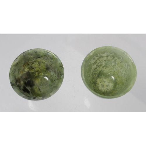 324 - Pair of Chinese mottled green jade cups, each 5cm high.  (2).