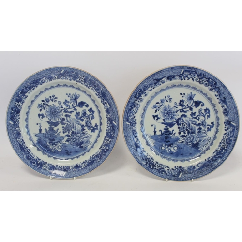 326 - Pair of 18th century Chinese blue and white porcelain plates, the central panels depicting gardens w... 