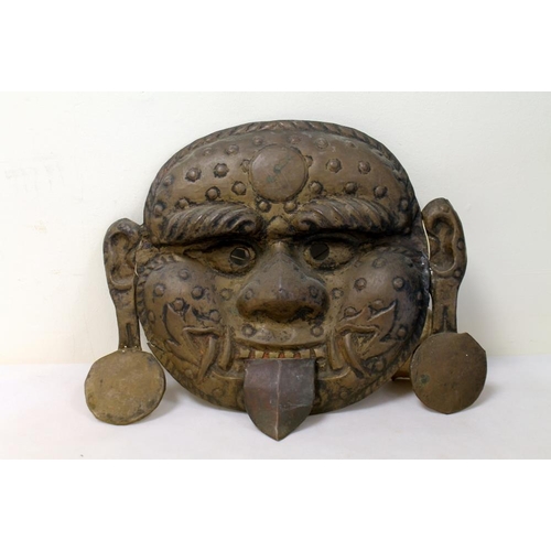 380 - Tibetan Mahakala bronze mask with repoussé features, protruding tongue, pendulous earlobes and fangs... 