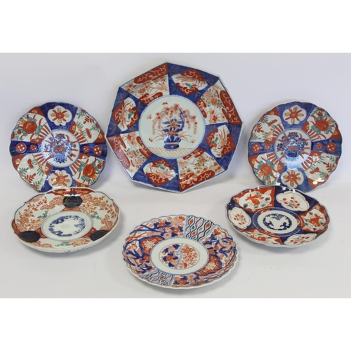 391 - Japanese Imari octagonal plate with central panel of a vase of flowers and smaller radiating panels ... 