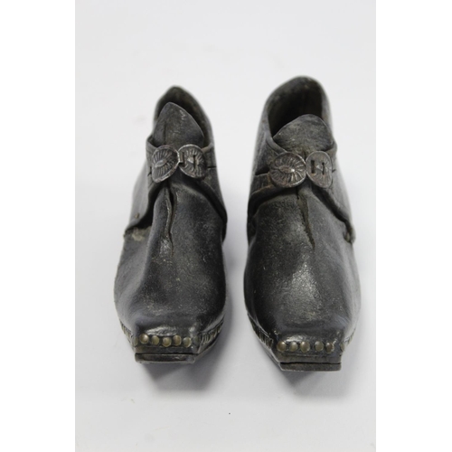 410 - Pair of 19th century child's clogs with metal buckles, riveted detail and steel to sole and heels, e... 