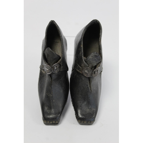 410 - Pair of 19th century child's clogs with metal buckles, riveted detail and steel to sole and heels, e... 