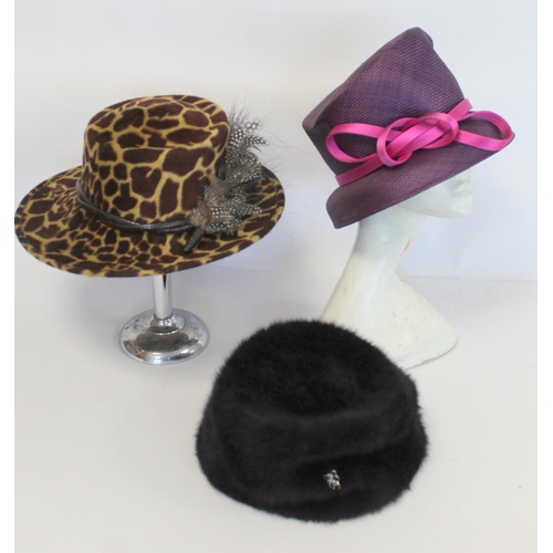 416 - Three Philip Treacy of London hats: faux leopard skin with feathers; dark plum straw with pink ribbo... 