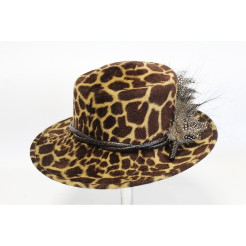 416 - Three Philip Treacy of London hats: faux leopard skin with feathers; dark plum straw with pink ribbo... 