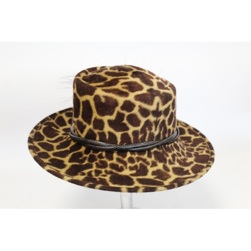 416 - Three Philip Treacy of London hats: faux leopard skin with feathers; dark plum straw with pink ribbo... 