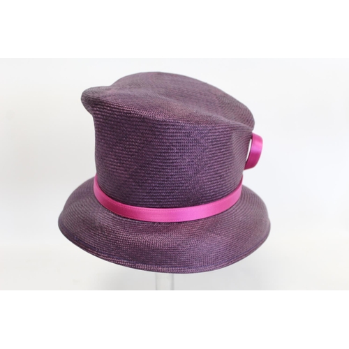 416 - Three Philip Treacy of London hats: faux leopard skin with feathers; dark plum straw with pink ribbo... 