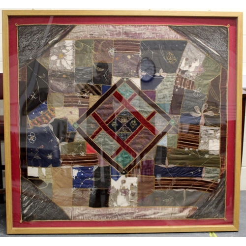 428 - A Victorian 'crazy' pattern patchwork quilt or panel with central diamond lozenge, in polychrome cot... 