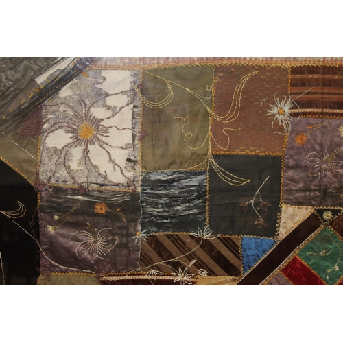 428 - A Victorian 'crazy' pattern patchwork quilt or panel with central diamond lozenge, in polychrome cot... 