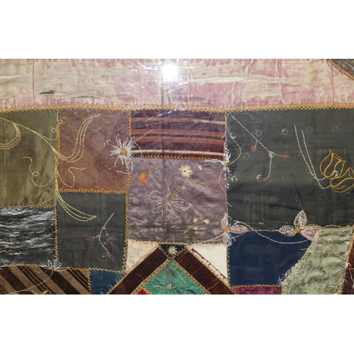 428 - A Victorian 'crazy' pattern patchwork quilt or panel with central diamond lozenge, in polychrome cot... 