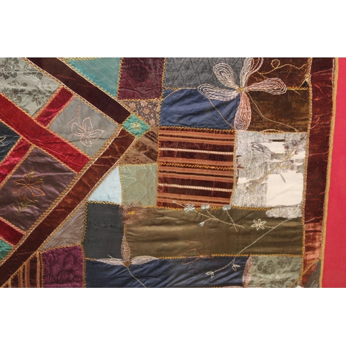 428 - A Victorian 'crazy' pattern patchwork quilt or panel with central diamond lozenge, in polychrome cot... 