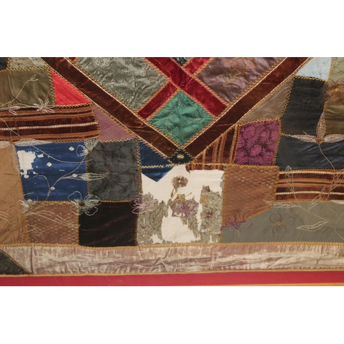 428 - A Victorian 'crazy' pattern patchwork quilt or panel with central diamond lozenge, in polychrome cot... 