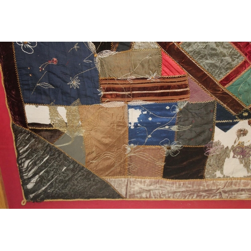 428 - A Victorian 'crazy' pattern patchwork quilt or panel with central diamond lozenge, in polychrome cot... 