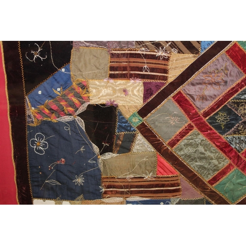 428 - A Victorian 'crazy' pattern patchwork quilt or panel with central diamond lozenge, in polychrome cot... 