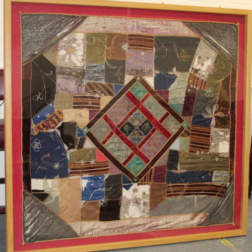 428 - A Victorian 'crazy' pattern patchwork quilt or panel with central diamond lozenge, in polychrome cot... 