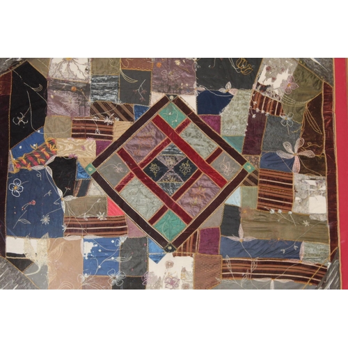 428 - A Victorian 'crazy' pattern patchwork quilt or panel with central diamond lozenge, in polychrome cot... 