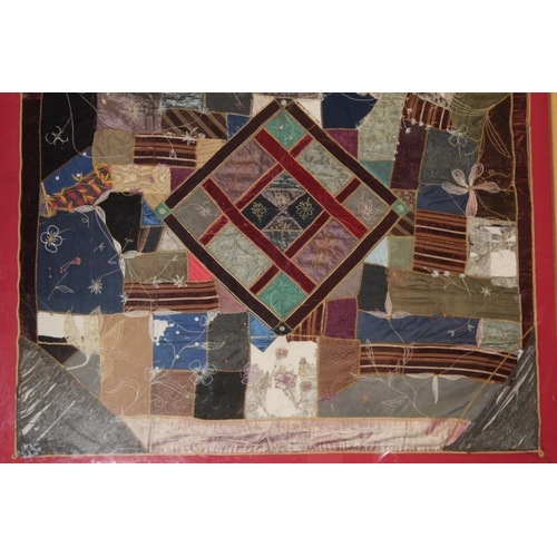 428 - A Victorian 'crazy' pattern patchwork quilt or panel with central diamond lozenge, in polychrome cot... 