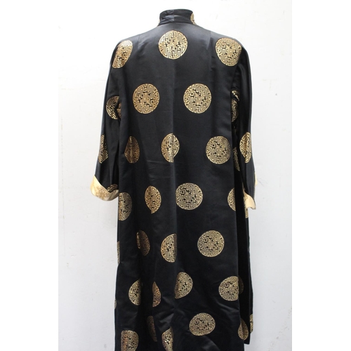 437 - Vintage Chinese reversible black and gold silk coat, with brocade medallions.