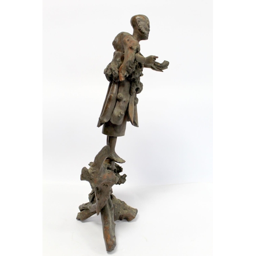 338 - 19th or early 20th century Oriental carved root wood figure of a peddler holding a shoe, the face wi... 