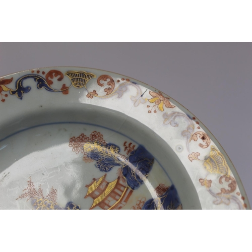 347 - Three 18th century Chinese porcelain soup plates decorated with pagodas in a landscape in underglaze... 