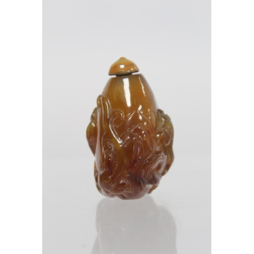 361 - 20th century Chinese dark yellow agate snuff bottle of pear form carved with Chilong with similarly ... 